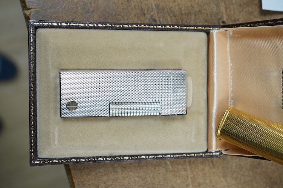 Two Dunhill Rollalite lighters, gold plated and silver, gold plated 7 cm high, Condition - fair to good